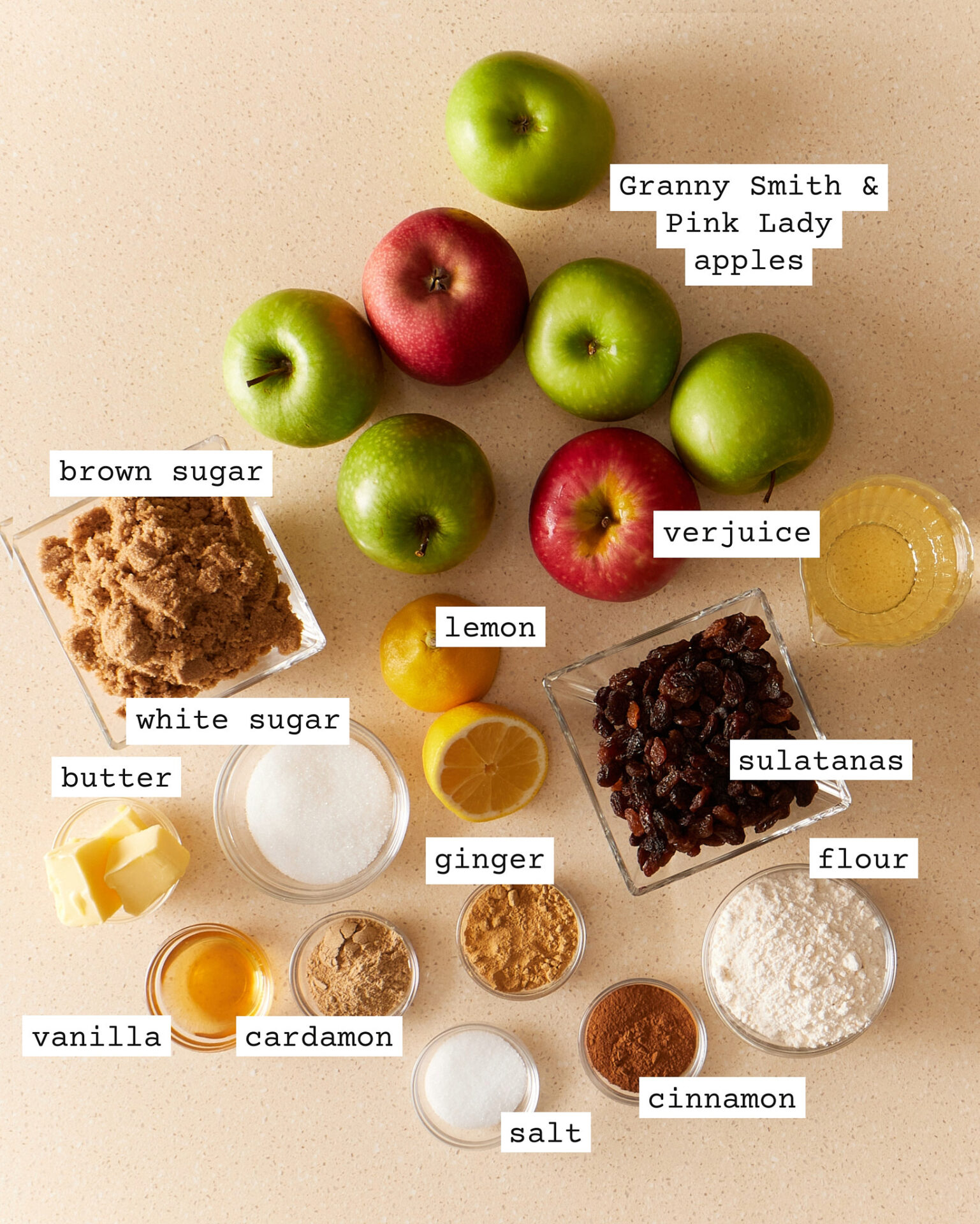 Delicious apple and sultana crinkle pie filling ingredients on the kitchen bench, including all the usual ingredients and verjuice and ground cardamon as secret ingredients.