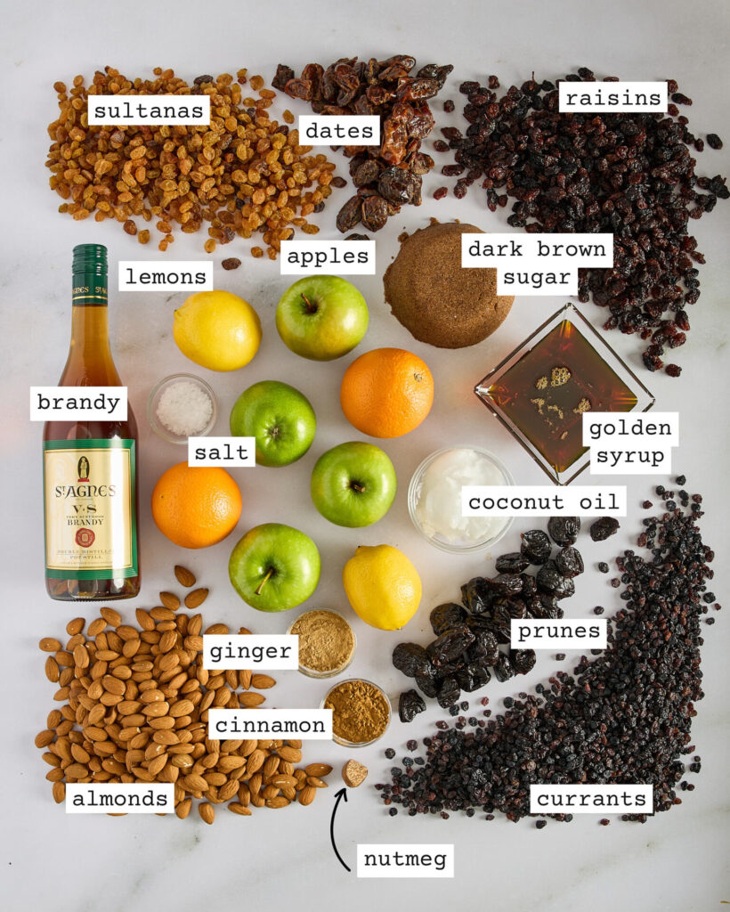 Labelled ingredients for fruit mince on a white marble bench top.