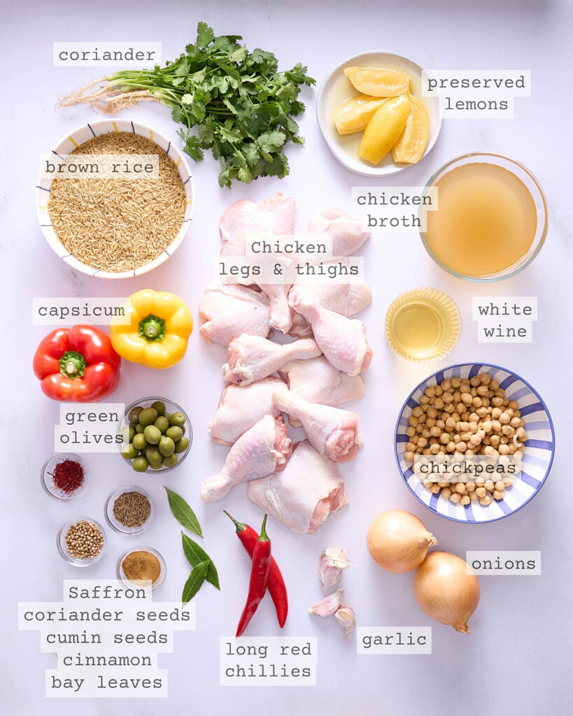 Moroccan chicken and rice ingredients on a white bench.