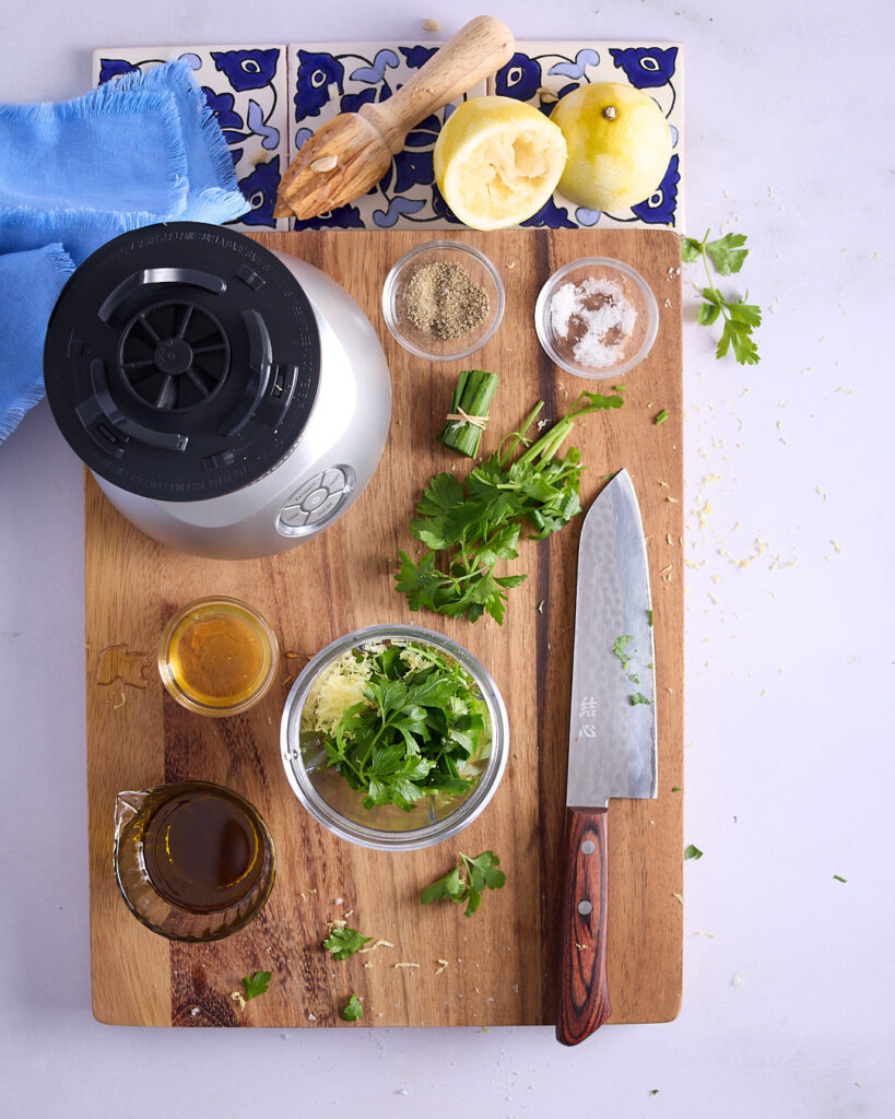 Vinaigrette dressing ingredients on a wooden cutting board ready to be blitzed.