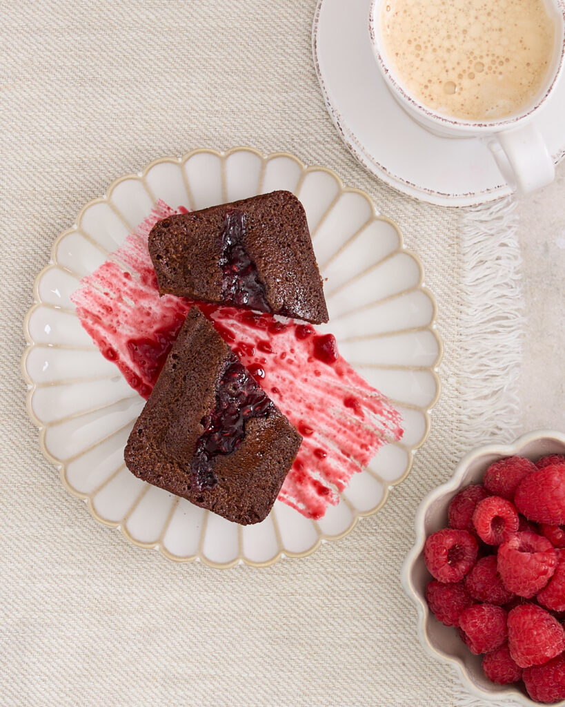Gluten free chocolate and raspberry financier served with coffee and fresh raspberries.