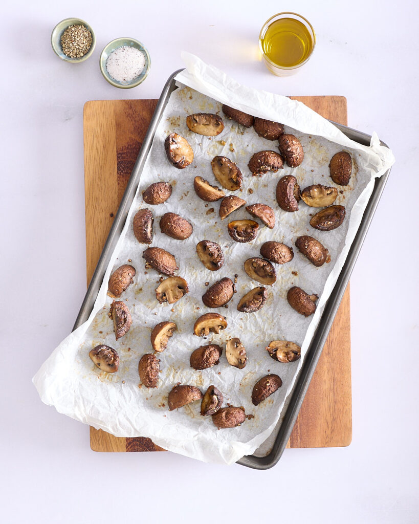 Tray of roasted Swiss brown mushrooms seasoned with truffle salt and white pepper.