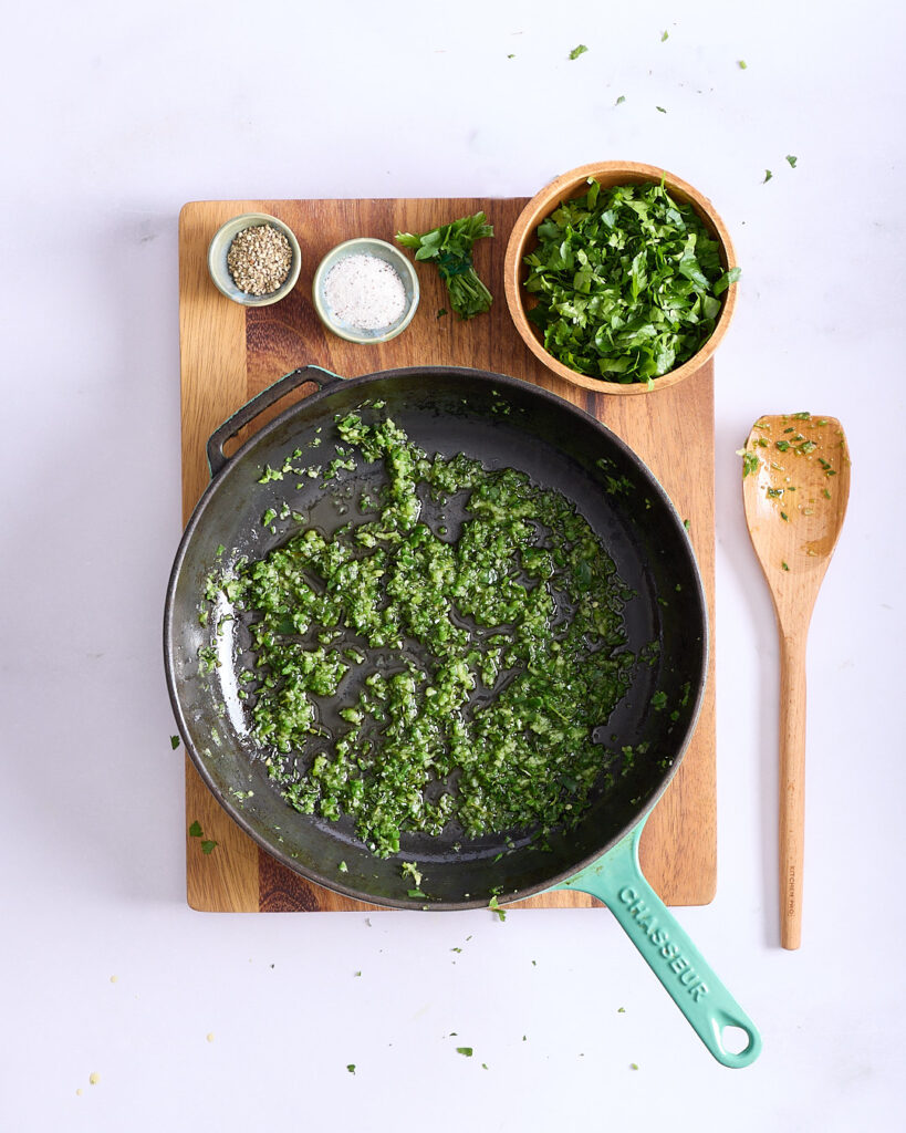 Pan of sautéed garlic, green chilli with parsley in olive oil, truffle salt and white pepper.