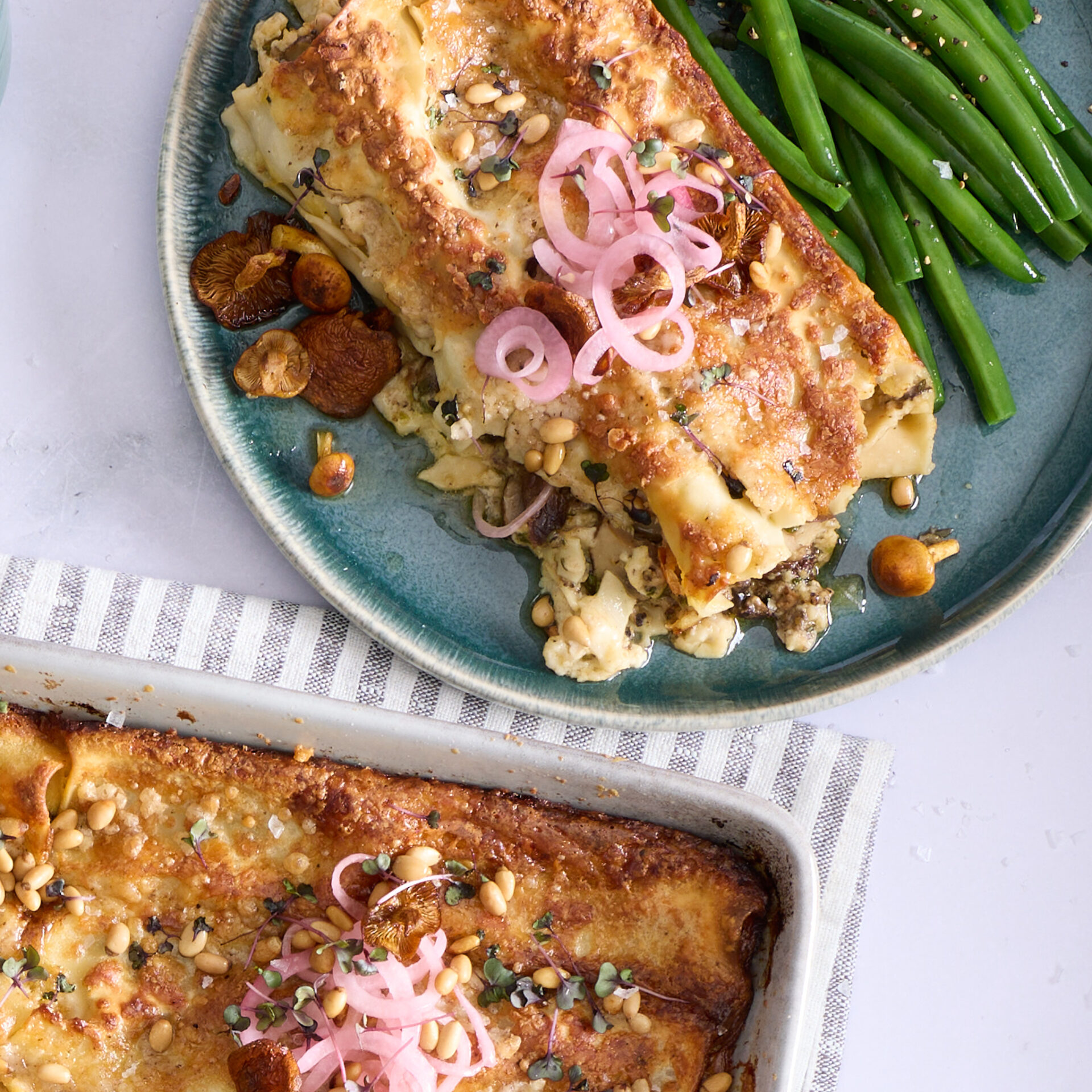 Baked truffled mushroom cannelloni in a creamy brie sauce, topped with pine nuts, pickled red onions and micro herbs.