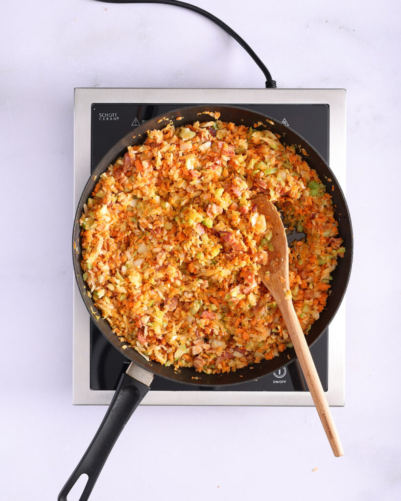 Sautéed roughly chopped carrot, celery, onion, garlic and bacon in a pan.