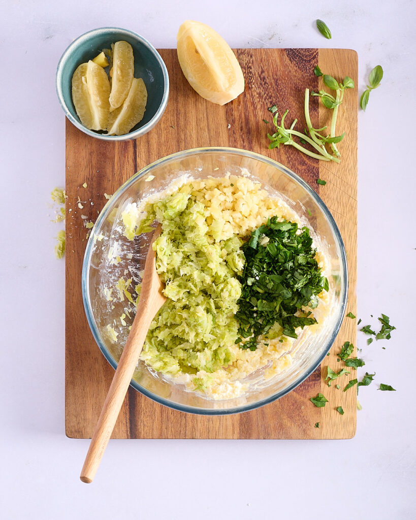Mixing bowl with cheesy panade, cooled leeks and herbs.