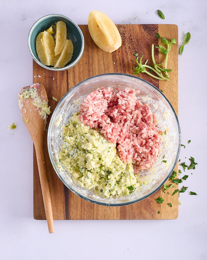 Ground pork added to bowl with leek, herb, and panade mixture.